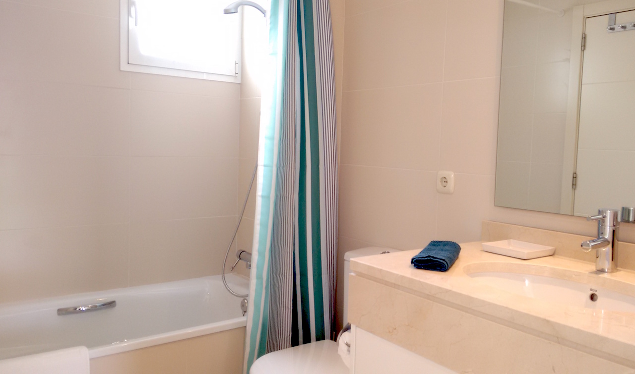 Image shows marbel bathroom with bath tub and shower