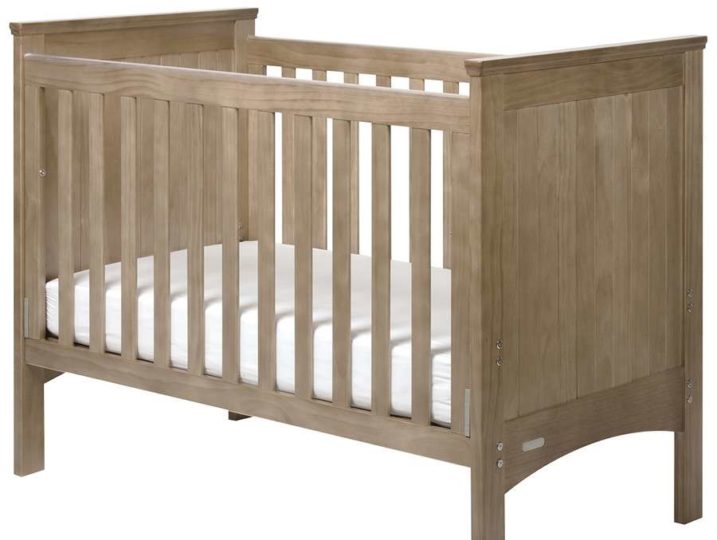 Image show a standard infants cot with wooden slats.