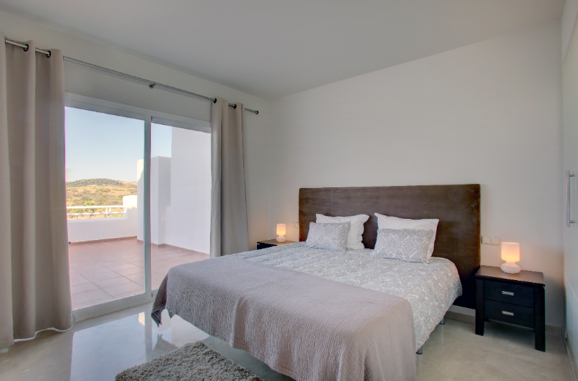 Image shows kingsize bed with views to terrace and alcazaba lagoon resort