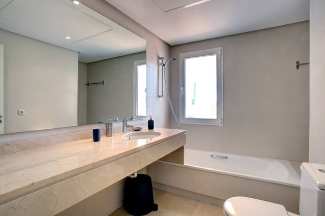 Image shows large bathroom with bath tub