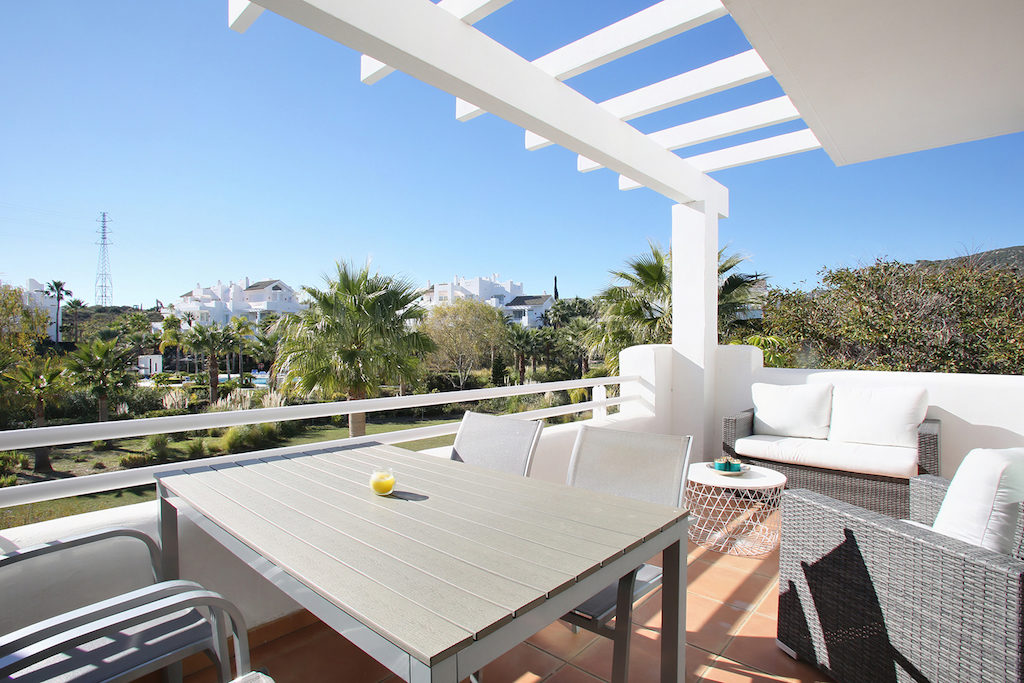 Image shows table charis and terrace furniture and views over pool