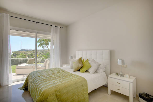 Image shoes large master bedroom and king size bed with views onto gardens