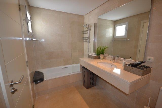 Image shows large marble bathroom