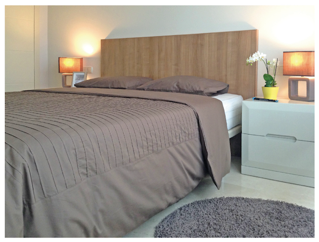 Image shows king size bed with designer furniture