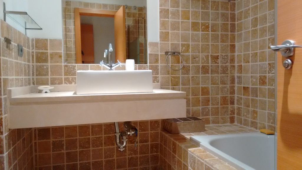 Image shows pristine bathroom with bathtub