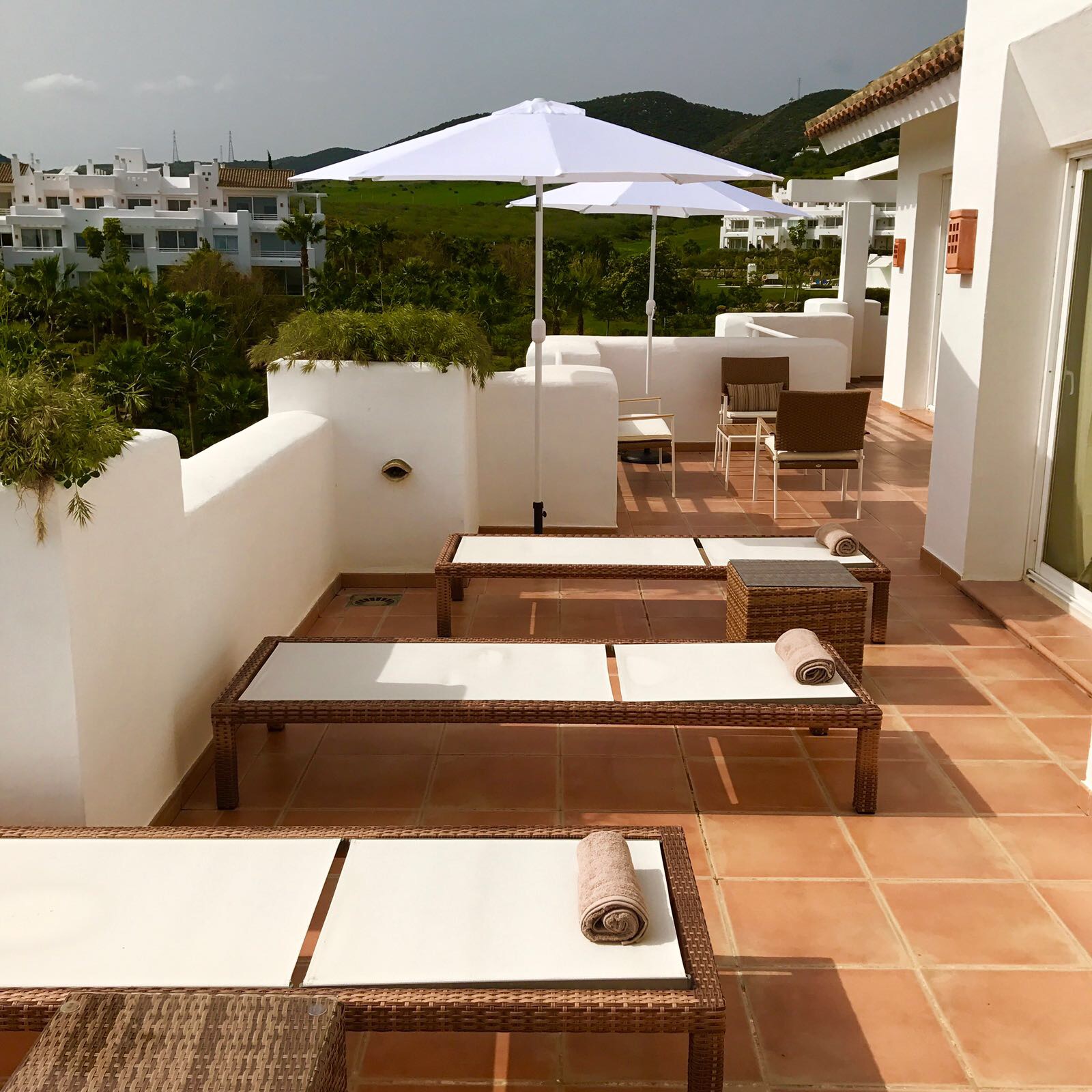 Image shows the second terrace with more outdoor furniture of this stylish penthouse in Alcazaba Lagoon